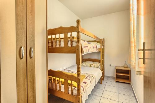 a bedroom with two bunk beds in a room at Apartments & Bungalows Ivanović in Kaštela