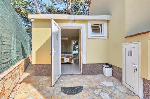 a house with a door open to a bedroom at Apartments & Bungalows Ivanović in Kaštela
