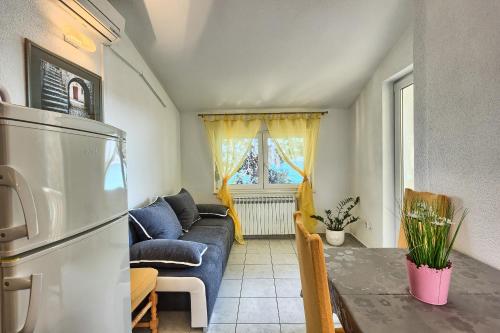a living room with a couch and a table at Apartments & Bungalows Ivanović in Kaštela