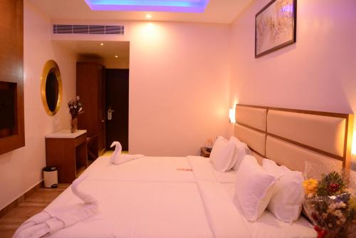 Ένα ή περισσότερα κρεβάτια σε δωμάτιο στο Kani Residency Hotel