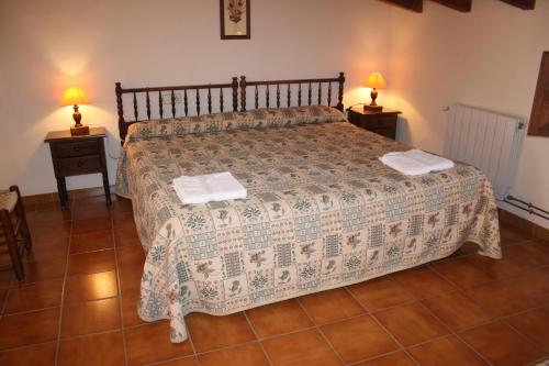 a bedroom with a large bed with two night stands at Masía La Safranera in Alcoy
