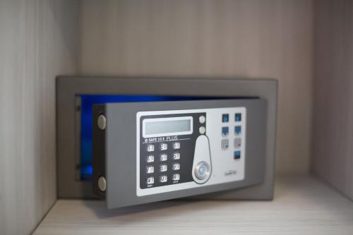 an image of a microwave oven with its door open at Alma Living Hotel- Al Girarrosto in Venzone