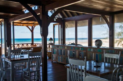 a restaurant with tables and chairs and the beach at Sentidos Beach Retreat in Miramar