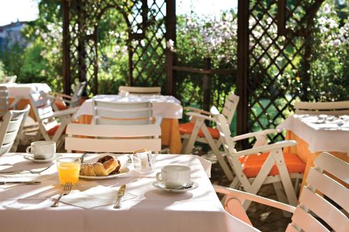 a table with a plate of food and drinks on it at Hotel Airone isola d'Elba in Portoferraio
