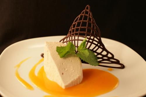 a piece of food on a white plate with a dessert at APIPURA hotel rinner in Soprabolzano