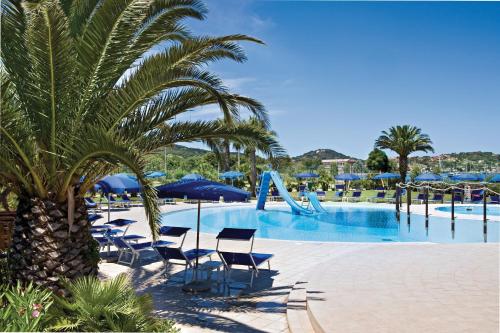 a pool with chairs and a slide at a resort at Hotel Airone isola d'Elba in Portoferraio