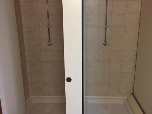 a shower with a glass door in a bathroom at Ubilla Aterpetxea in Aulestia