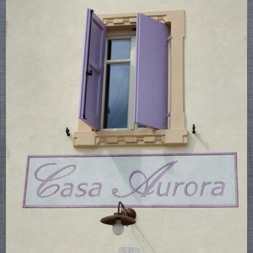 a window and a sign on the side of a building at Agriturismo Casa Aurora in Bussolengo