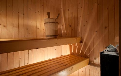 a inside of a sauna with a bucket on a shelf at Hotel Nord Est in Cattolica