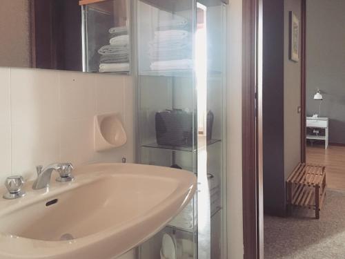 a white bathroom with a sink and a tv at Sunny family apartment in villa - HUMANITAS FORUM IEO in Pieve Emanuele