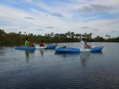 three people are sitting in kayaks on a lake at Sentidos Beach Retreat in Miramar