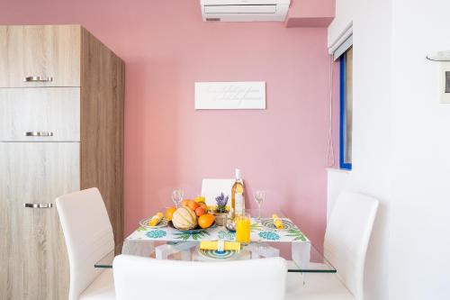 a dining room with a table with fruit on it at Seaview Luxury Penthouse with Shared Swimming Pool in Għajnsielem