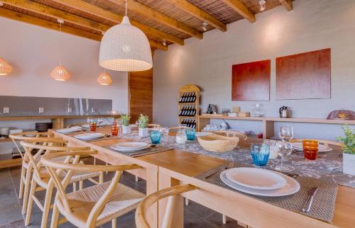 a dining room with a large wooden table and chairs at Monte Velho Equo-Resort in Arraiolos