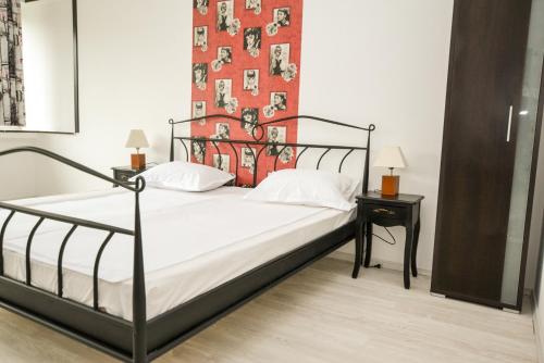 a bedroom with a black bed with a red wall at Central Class Bucharest in Bucharest