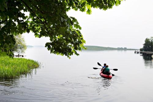 two people in a kayak on a lake at Lusty Beg Island in Kesh