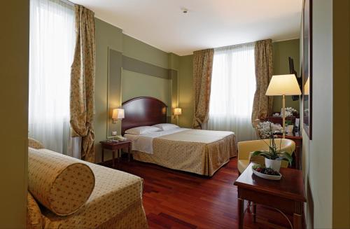 Кровать или кровати в номере Savoia Hotel Regency