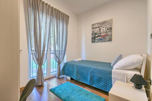 a bedroom with a bed and a window at Adriatic Apartments Fažana in Fažana