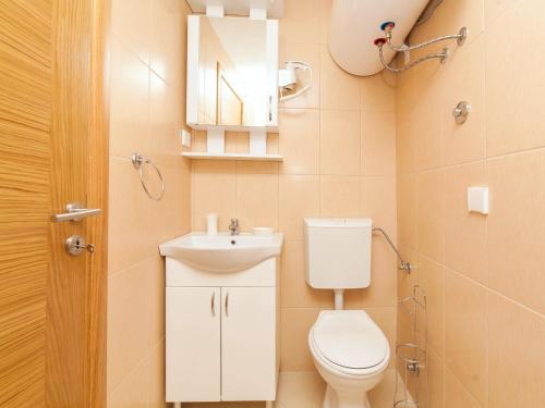 a small bathroom with a toilet and a sink at Apartments Kaleta in Kotor