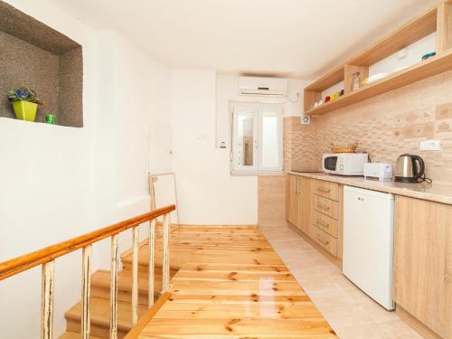 a kitchen with a staircase leading up to a room at Apartments Kaleta in Kotor