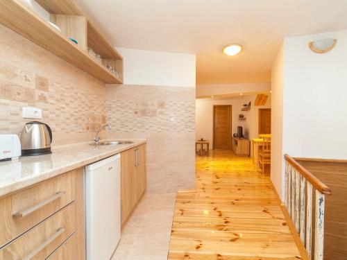a kitchen with wooden counters and a wooden floor at Apartments Kaleta in Kotor