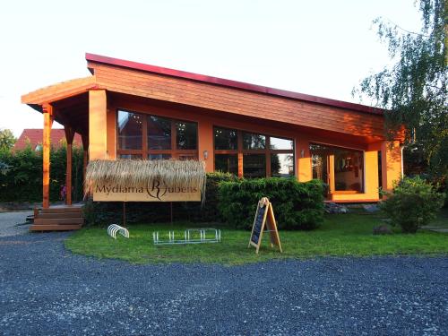 a small house with a sign in front of it at Pension Růžák in Růžová