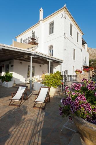 a group of chairs sitting in front of a building at Four Seasons Hydra Luxury Suites in Hydra