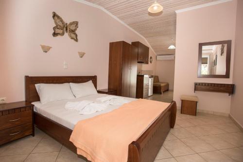 a bedroom with a bed with butterflies on the wall at Korali House in Paralia Vrachou