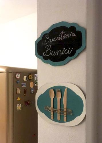 a sign on the side of a refrigerator with utensils at Frăgăria in Zimandcuz