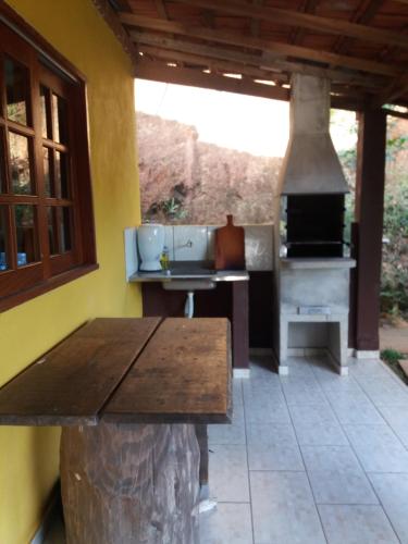 una cucina con tavolo in legno e forno di Sítio da Dinda - Campos do Jordão a Rosas