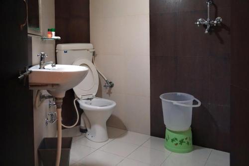 a bathroom with a toilet and a sink at Hotel Laxmi Palace in Udaipur