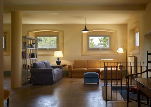 a living room with a couch and a chair at B&B Palazzolo La Foce in Chianciano Terme