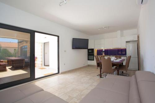 a living room with a table and a dining room at Villa Marijeta Hvar in Hvar