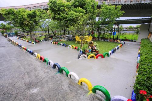 a playground in a park with colorful barriers at Sweetheart Homestay in Luodong