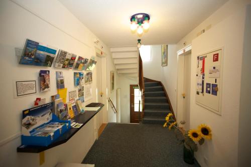 a hallway with a staircase and a stair case at Adventure Guesthouse Interlaken in Interlaken
