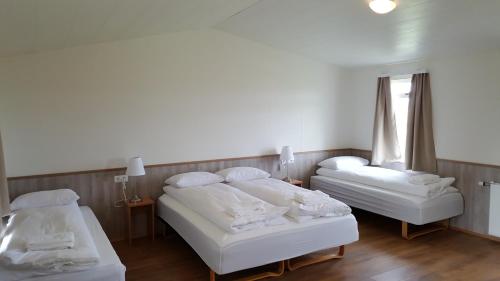 Säng eller sängar i ett rum på Guesthouse Stöng and Cottages