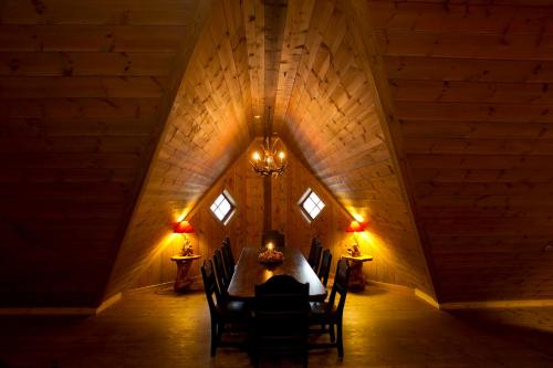 a dining room with a table and chairs in an attic at Flåmsbrygga Hotel in Flåm