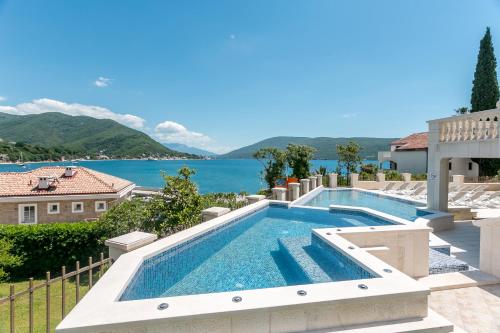 a swimming pool with a view of the water at Boutique Hotel Kredo in Herceg-Novi