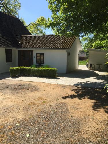 a white building with a bench in front of it at Holiday House Billundvej 74 in Randbøl