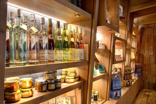 a room with many bottles of alcohol on shelves at LA CHENEAUDIÈRE - Hôtel Spa - Relais & Châteaux - Restaurant étoilé in Colroy-la-Roche