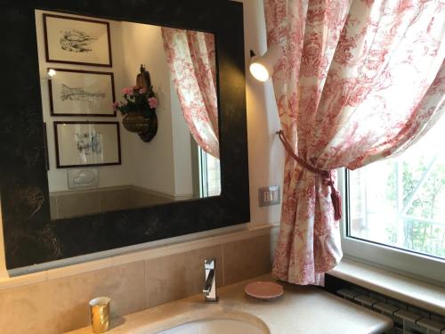 a bathroom with a sink and a mirror and a window at Relais Il Margarito in Montefano