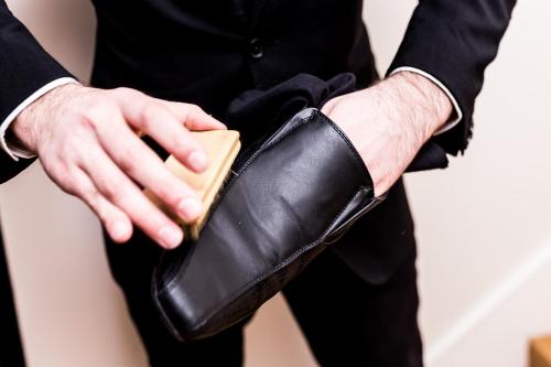 a man holding a wallet in his hand at The Scotsman Hotel in Edinburgh