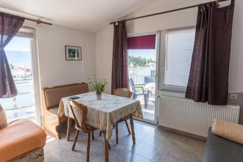 a dining room with a table and a balcony at Apartments Laura in Blace