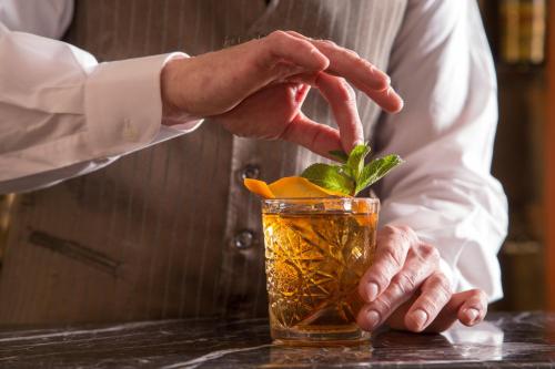 a man is putting a drink in a cocktail at La Residenza in Rome