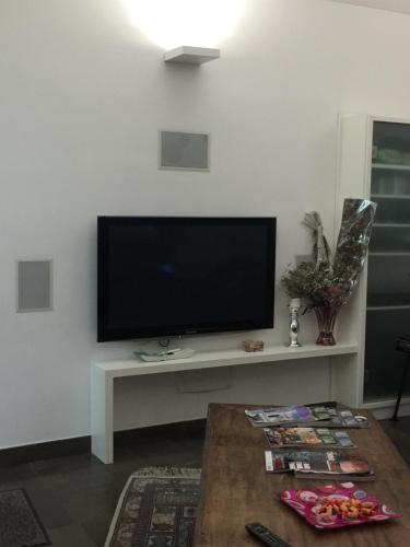 a living room with a flat screen tv on a white wall at Villa Maria in Turin