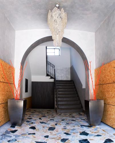 a hallway with a staircase and a chandelier at SoloSonno in Lecco