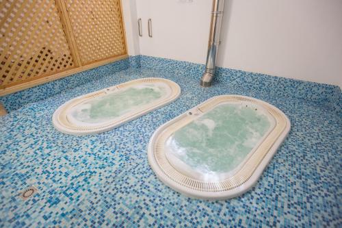 a bath tub sitting on the floor of a bathroom at Hotel Mediterraneo in Vieste