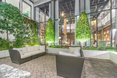a building with two couches and trees in front of it at Proximity Hotel in Greensboro