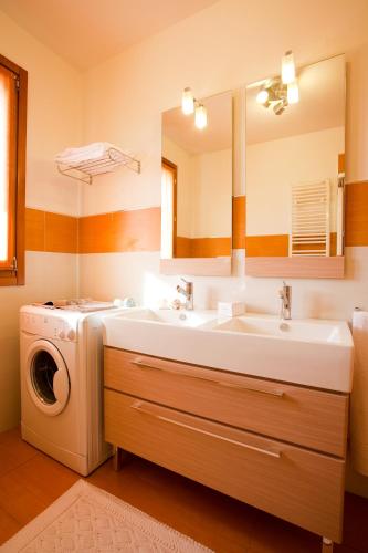 a bathroom with a sink and a washing machine at Residence Speranza in Lido di Jesolo