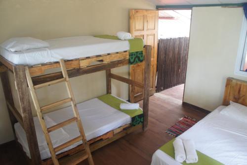 two bunk beds in a room with a mirror at Cebaco Sunrise Lodge in Isla Cebaco 