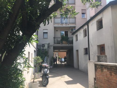 a scooter parked in an alley next to a building at Residenza Giacomuzzi in Mestre